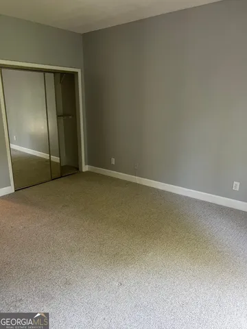 an empty room with a empty space and windows