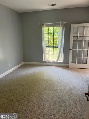 a bathroom with a granite countertop sink and a toilet