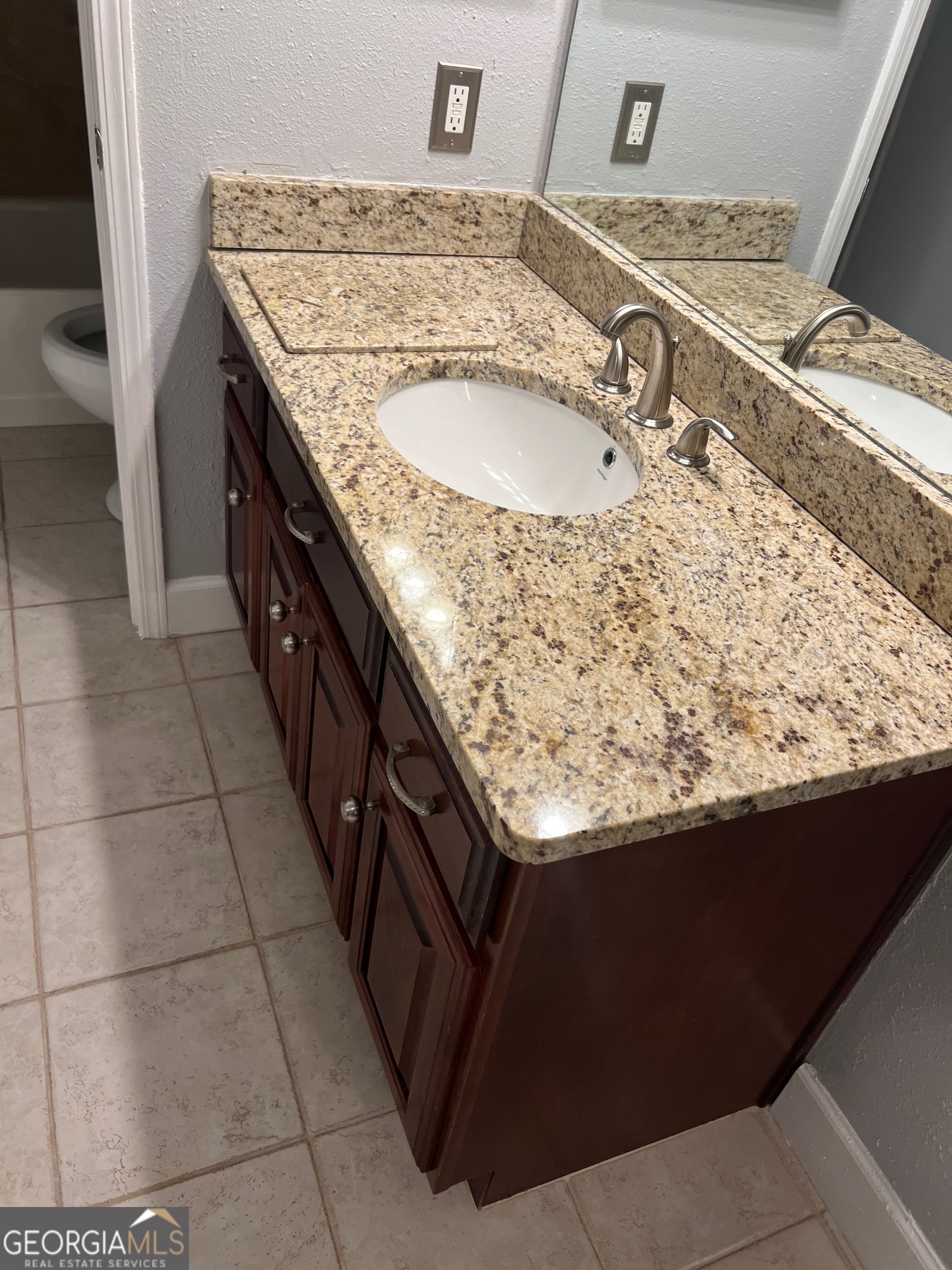 3071 Lenox Road Northeast, Unit 39 Atlanta, GA 30324 - Photo 28 of 29 a bathroom with a granite countertop sink and washing machine