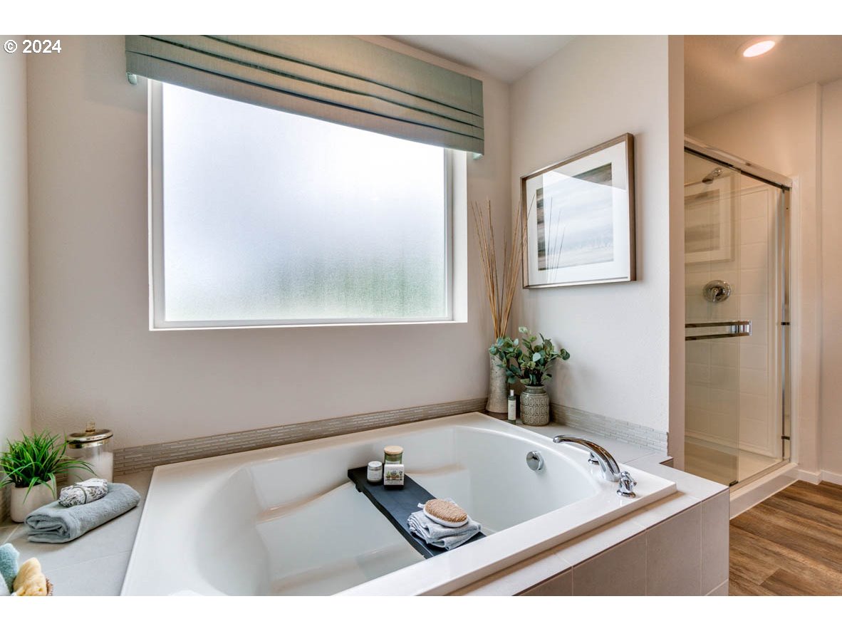 2791 U Street Springfield, OR 97477 - Photo 28 of 29 a bath tub sitting in a bathroom next to a window