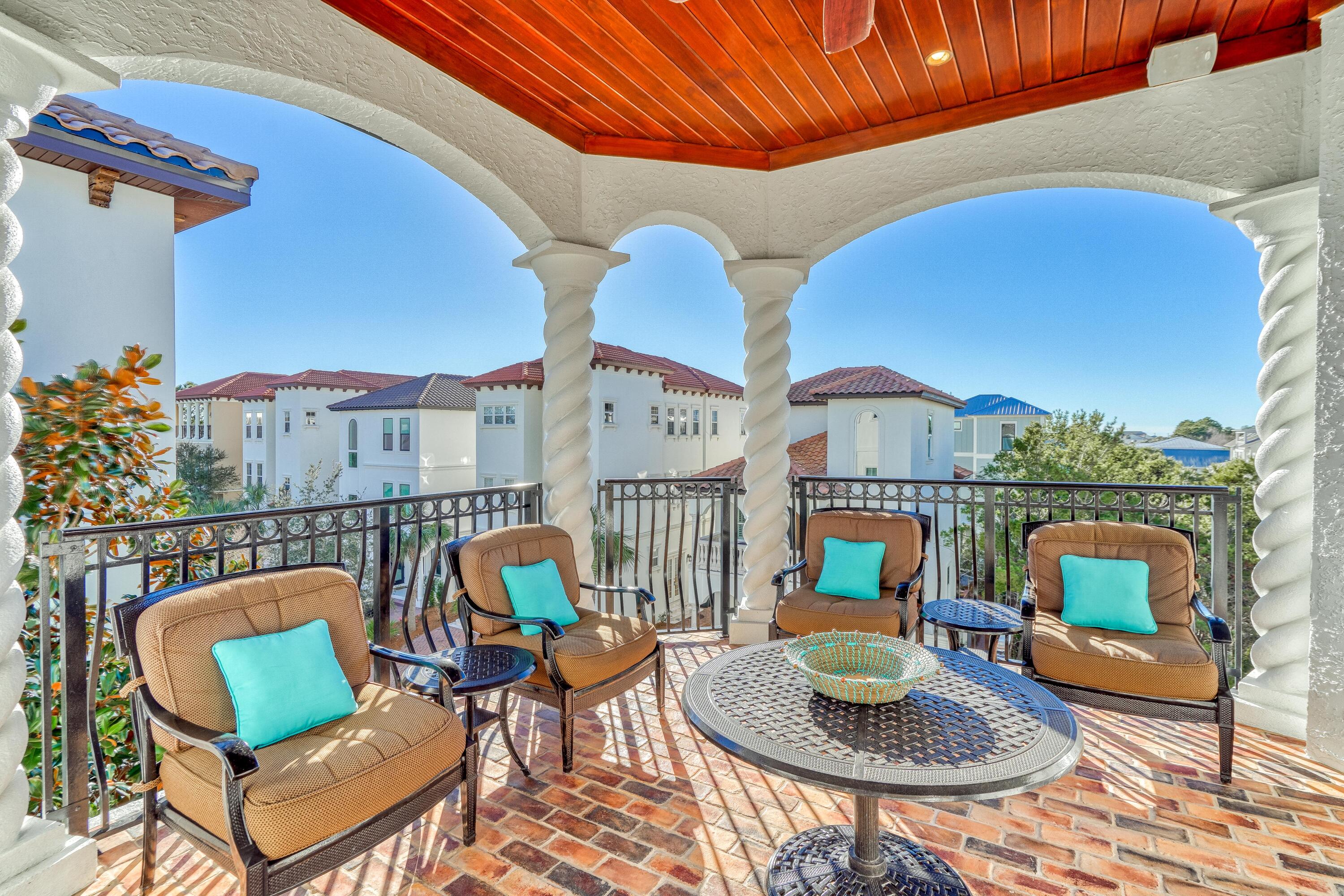 89 Palmeira Way Santa Rosa Beach, FL 32459 - Photo 18 of 64 a view of a patio with couches table and chairs under an umbrella