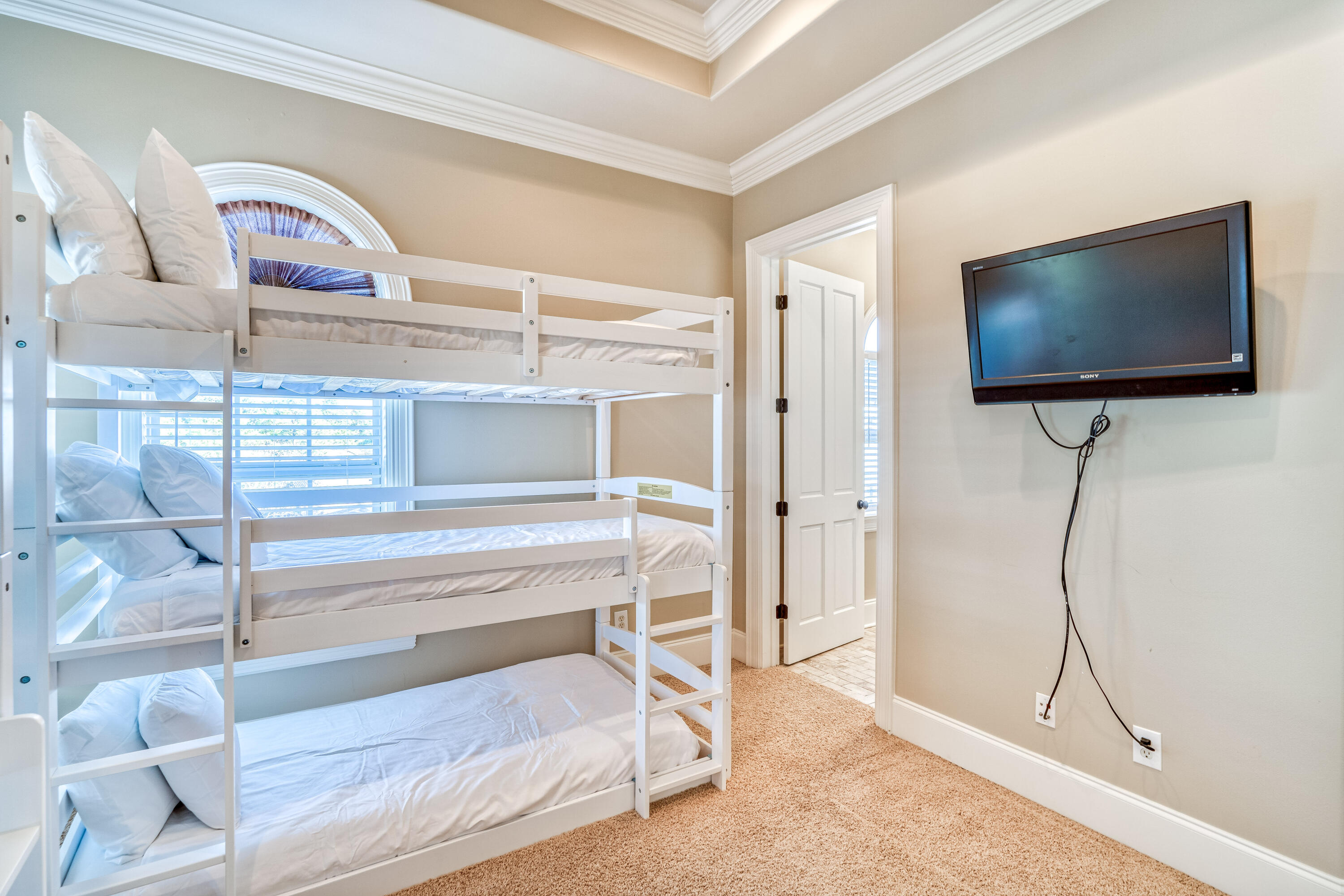 89 Palmeira Way Santa Rosa Beach, FL 32459 - Photo 41 of 64 a bedroom with a bed and a flat screen tv