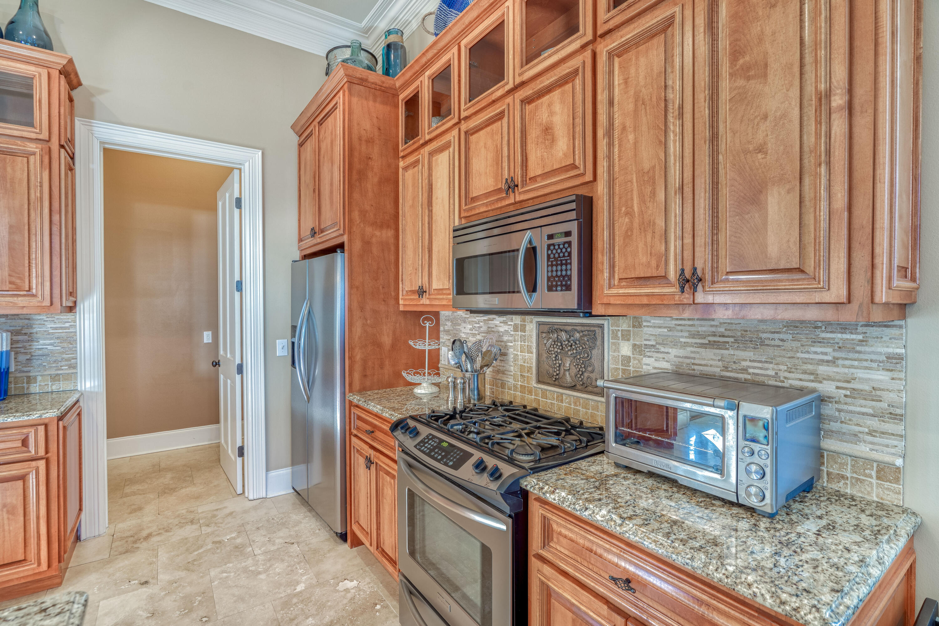 89 Palmeira Way Santa Rosa Beach, FL 32459 - Photo 6 of 64 a kitchen with stainless steel appliances granite countertop a stove a washer and dryer