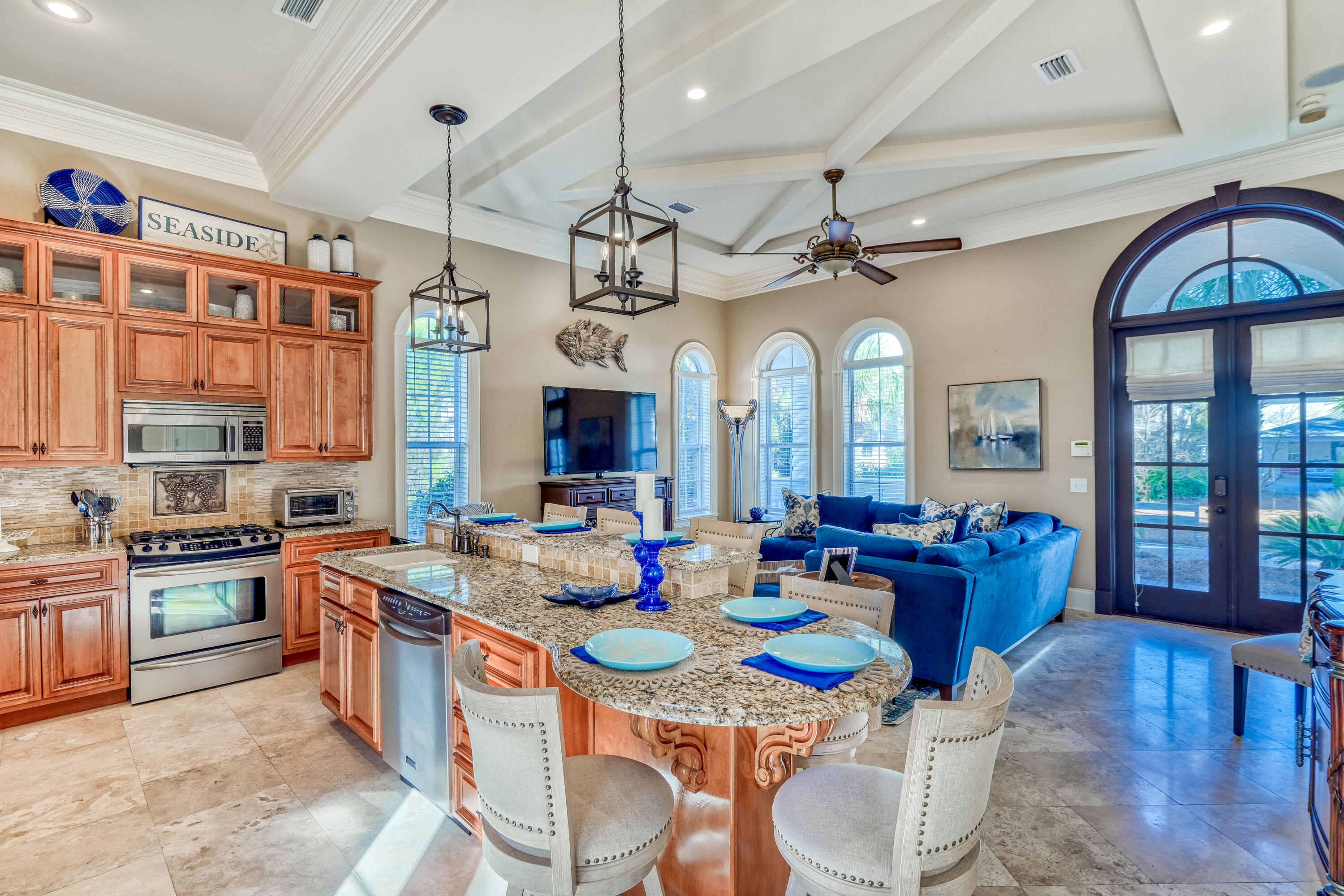 89 Palmeira Way Santa Rosa Beach, FL 32459 - Photo 9 of 64 a large kitchen with stainless steel appliances granite countertop a stove a sink dishwasher a dining table and chairs with wooden floor
