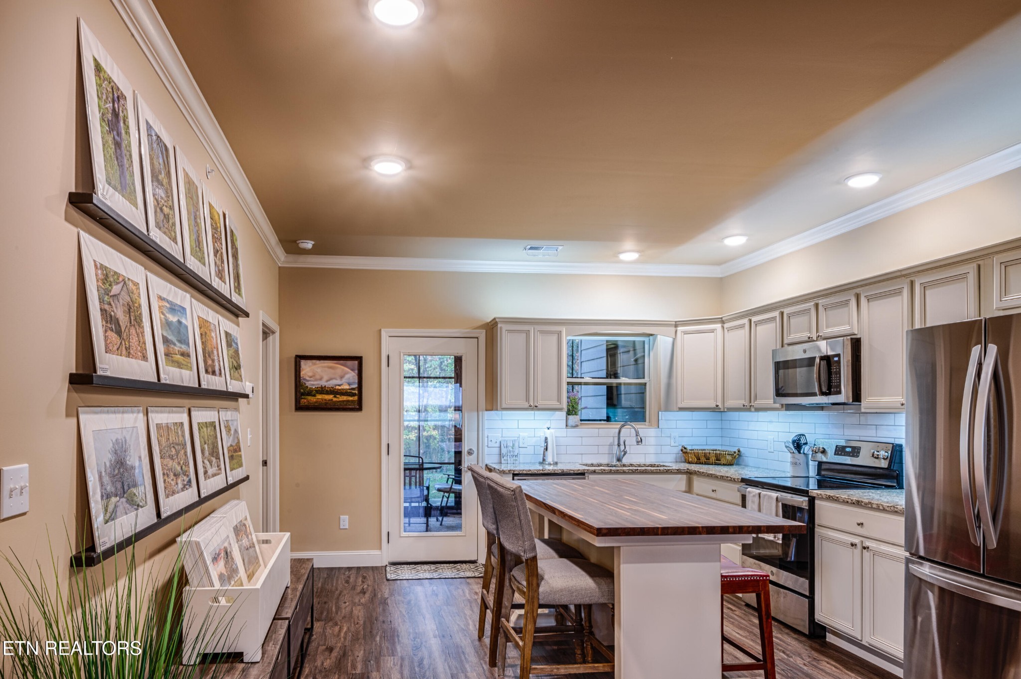 229 Bishops Cap Circle, Unit 101 Townsend, TN 37882 - Photo 11 of 47 a kitchen with stainless steel appliances granite countertop a refrigerator a stove top oven a sink dishwasher and white cabinets with wooden floor