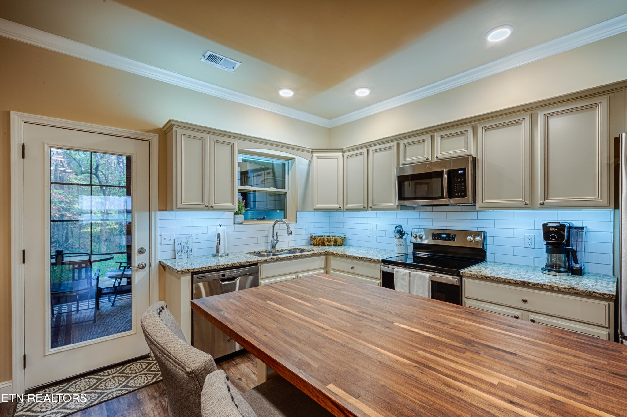 229 Bishops Cap Circle, Unit 101 Townsend, TN 37882 - Photo 13 of 47 a kitchen with stainless steel appliances a stove sink microwave and cabinets