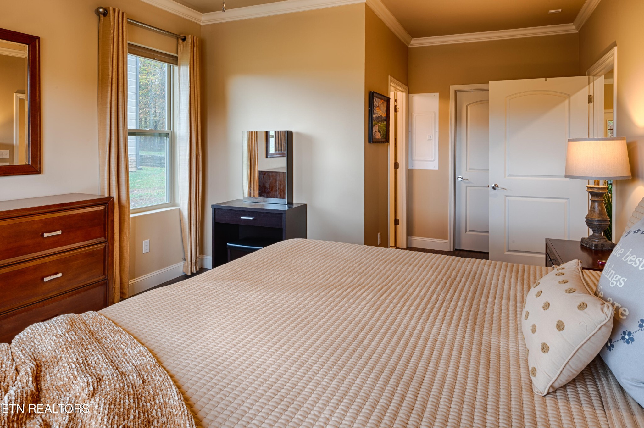 229 Bishops Cap Circle, Unit 101 Townsend, TN 37882 - Photo 23 of 47 a bedroom with a bed and a lamp on dresser