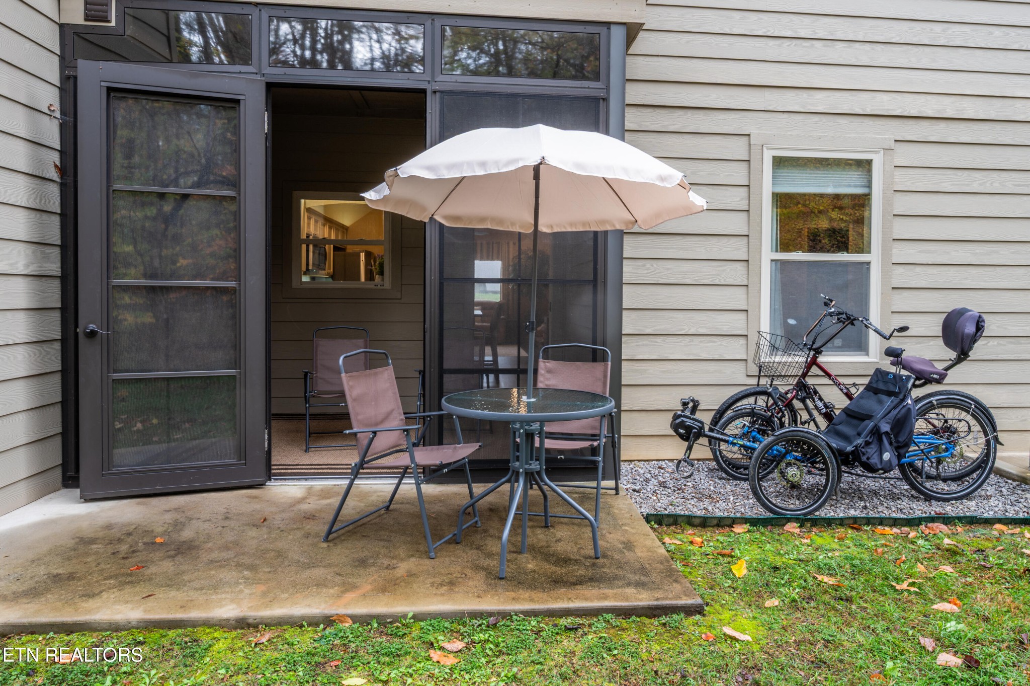 229 Bishops Cap Circle, Unit 101 Townsend, TN 37882 - Photo 40 of 47 a view of a patio with table and chairs under an umbrella