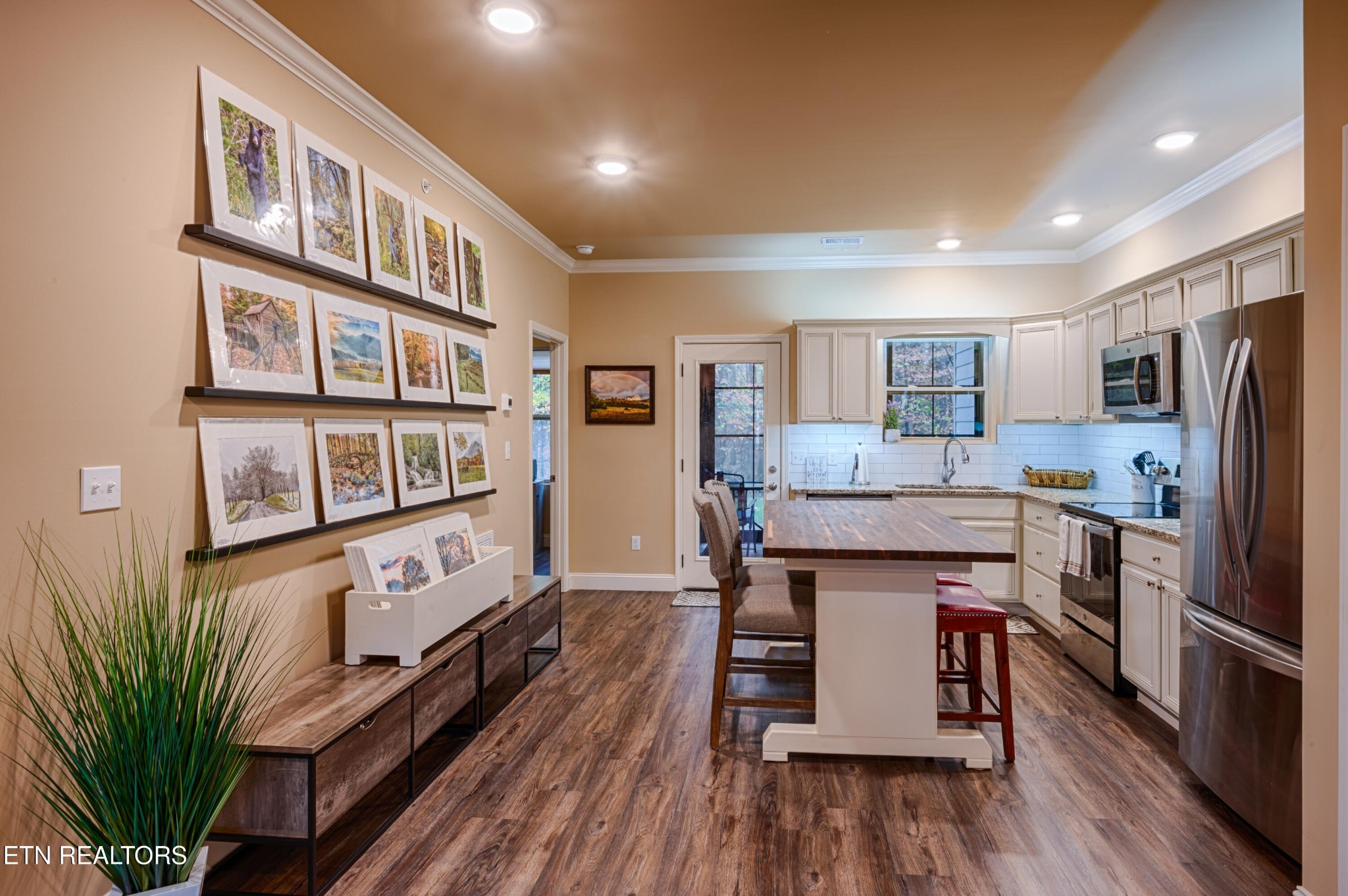229 Bishops Cap Circle, Unit 101 Townsend, TN 37882 - Photo 10 of 47 a kitchen with stainless steel appliances granite countertop a refrigerator a stove top oven a dining table and chairs with wooden floor