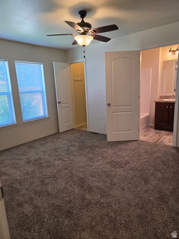 1275 Thrush Road Salt Lake City, UT 84123 - Photo 17 of 20 Spacious room featuring neutral carpet flooring, two windows, and a ceiling fan