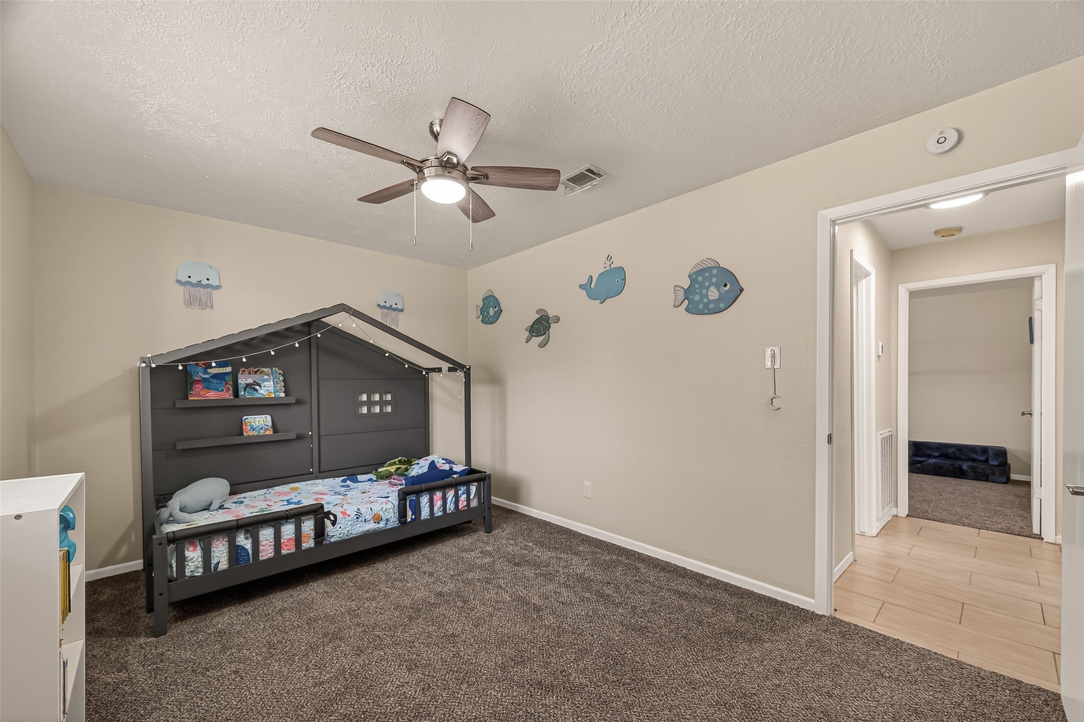 555 Shealy Street Houston, TX 77598 - Photo 17 of 41 a bedroom with a bed and a ceiling fan