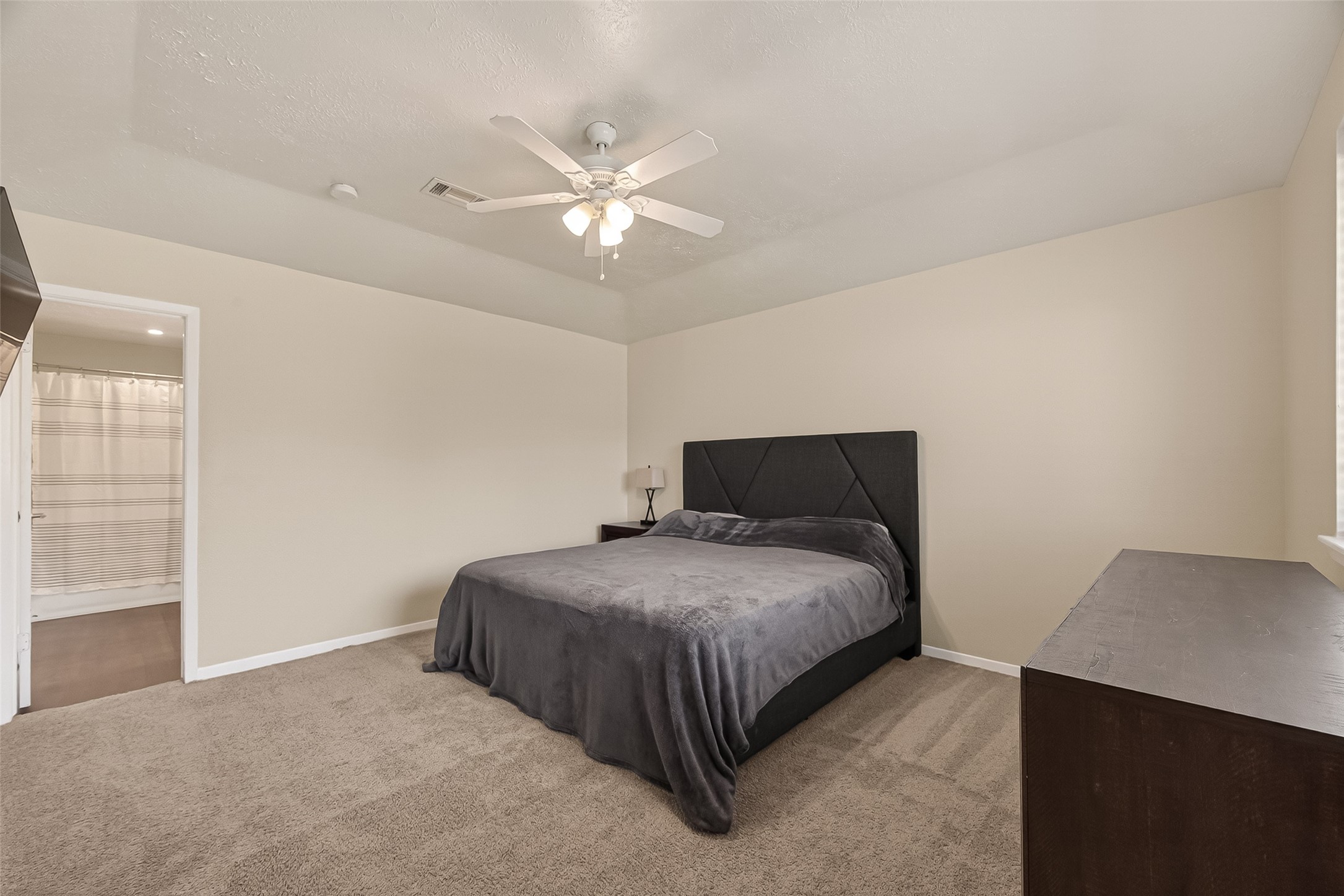 555 Shealy Street Houston, TX 77598 - Photo 25 of 41 a bedroom with a bed and a chandelier