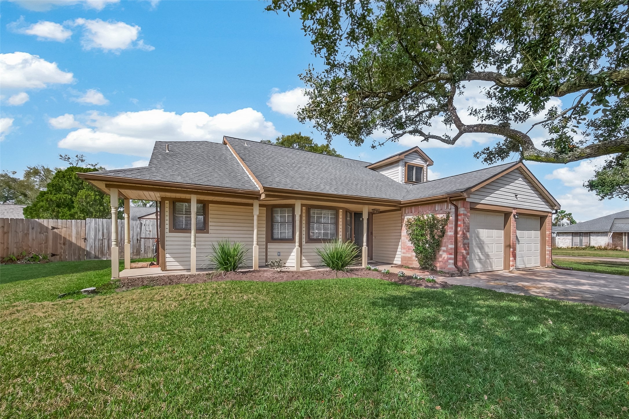 555 Shealy Street Houston, TX 77598 - Photo 3 of 41 a front view of a house with a yard and trees