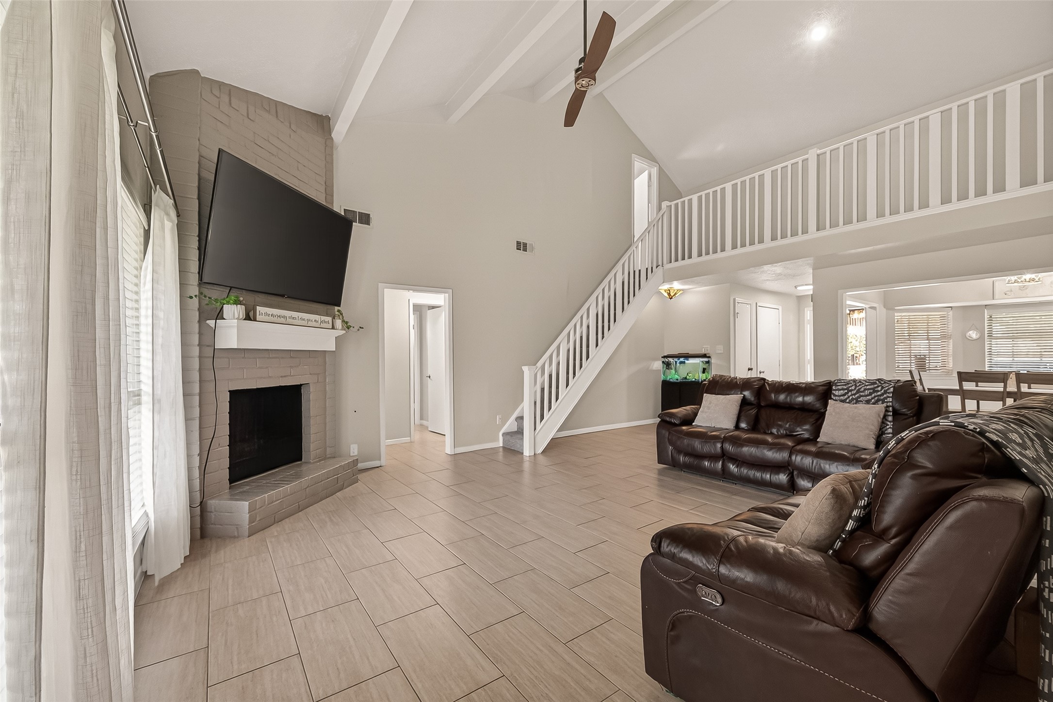 555 Shealy Street Houston, TX 77598 - Photo 7 of 41 a living room with furniture a flat screen tv and a fireplace