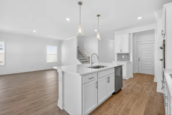 a kitchen with sink a stove and cabinets