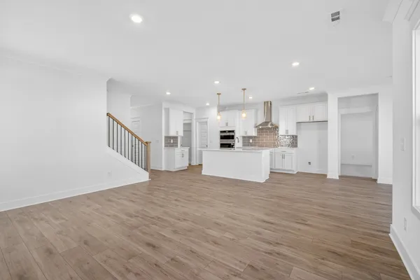 a view of kitchen with kitchen island and stainless steel appliances