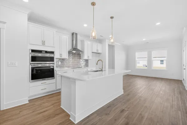 a kitchen with granite countertop a sink and cabinets