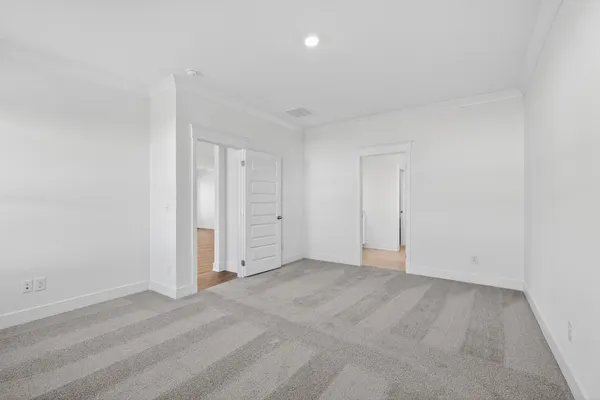 an empty room with closet and natural light