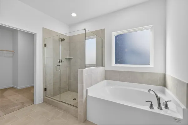 a bathroom with a bathtub and shower