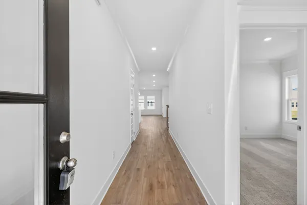 a view of hallway with wooden floor