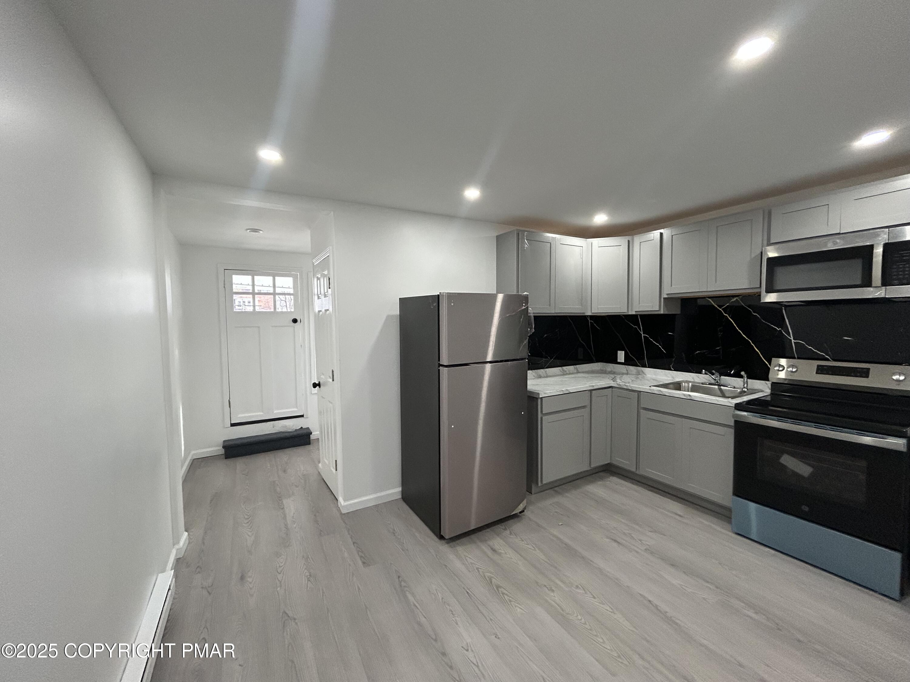 222 East Patterson Street, Unit 4 Lansford, PA 18232 - Photo 7 of 16 a kitchen with a refrigerator a sink and a stove top oven