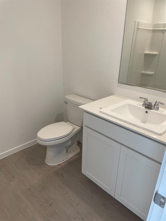 1021 Raintree Road Princeton, TX 75407 - Photo 12 of 16 Bathroom with vanity and dark wood finished floors