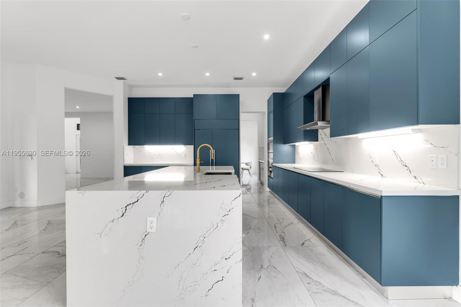 4950 Southwest 158th Ave Ranches Southwest Ranches, FL 33331 - Photo 14 of 75 a large white kitchen with stainless steel appliances kitchen island a stove a refrigerator a oven and a sink