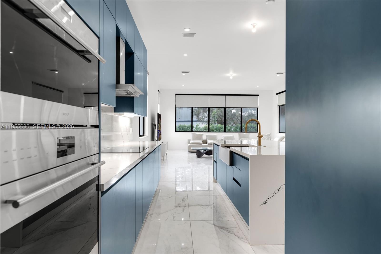 4950 Southwest 158th Ave Ranches Southwest Ranches, FL 33331 - Photo 16 of 75 a kitchen with stainless steel appliances a stove sink and cabinets