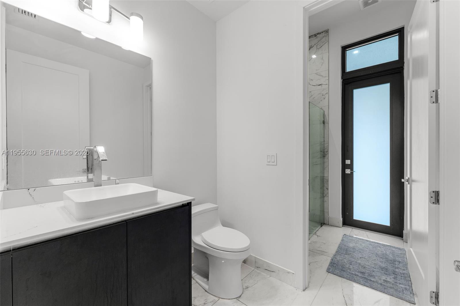 4950 Southwest 158th Ave Ranches Southwest Ranches, FL 33331 - Photo 19 of 75 a bathroom with a sink a toilet and shower