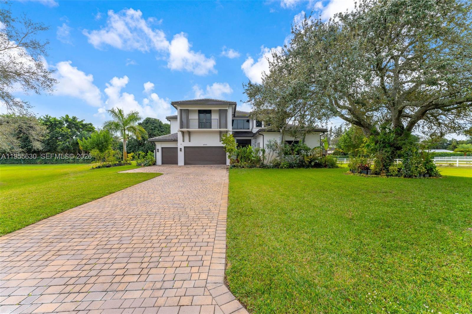 4950 Southwest 158th Ave Ranches Southwest Ranches, FL 33331 - Photo 2 of 75 a front view of a house with garden