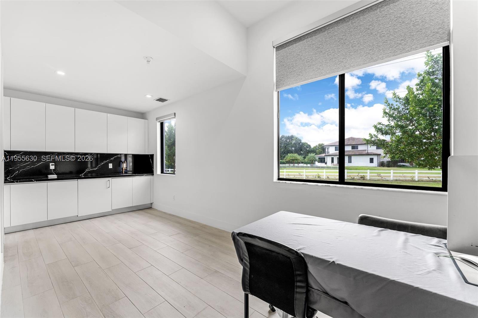 4950 Southwest 158th Ave Ranches Southwest Ranches, FL 33331 - Photo 21 of 75 a view of a kitchen with kitchen island a sink wooden floor and a window