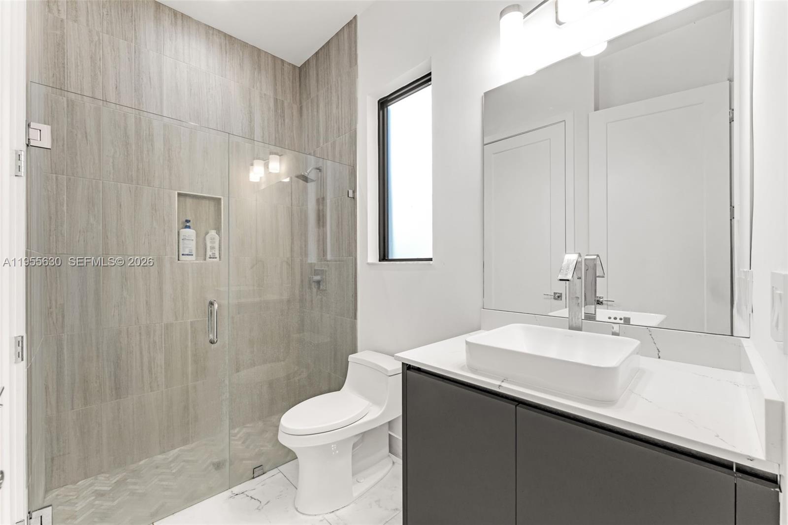 4950 Southwest 158th Ave Ranches Southwest Ranches, FL 33331 - Photo 23 of 75 a bathroom with a sink a toilet and shower