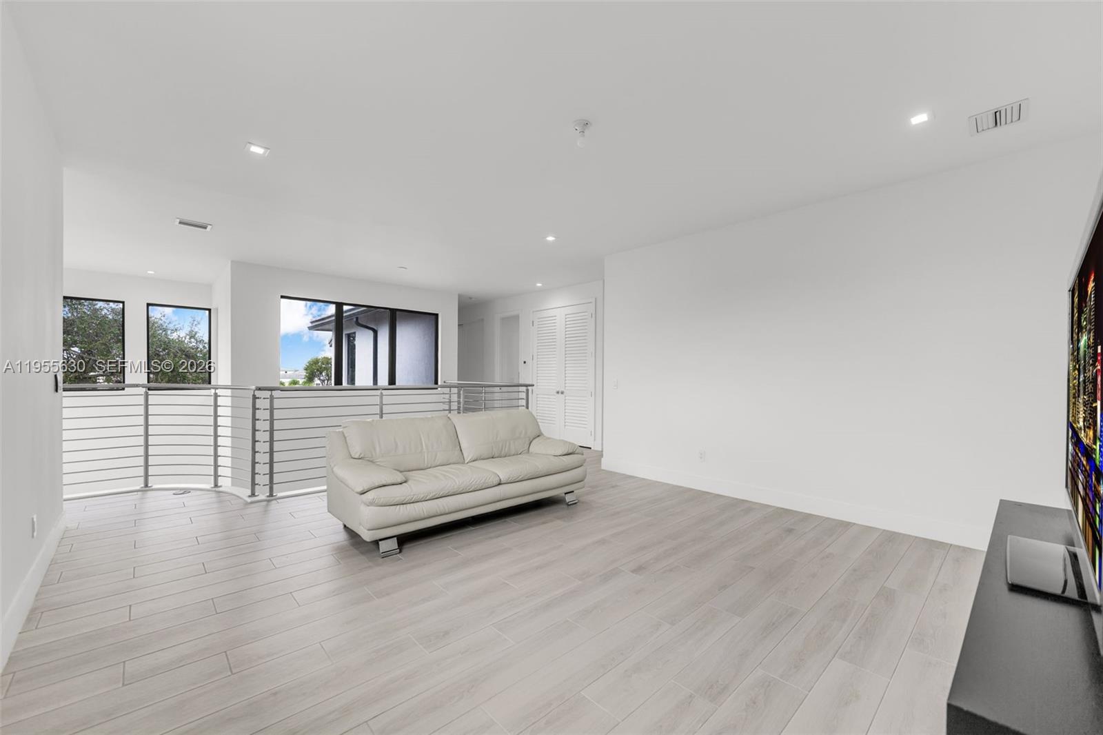 4950 Southwest 158th Ave Ranches Southwest Ranches, FL 33331 - Photo 28 of 75 a living room with furniture and a wooden floor