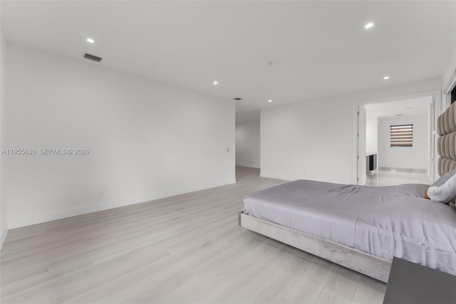 4950 Southwest 158th Ave Ranches Southwest Ranches, FL 33331 - Photo 34 of 75 a spacious bedroom with a bed and a dresser