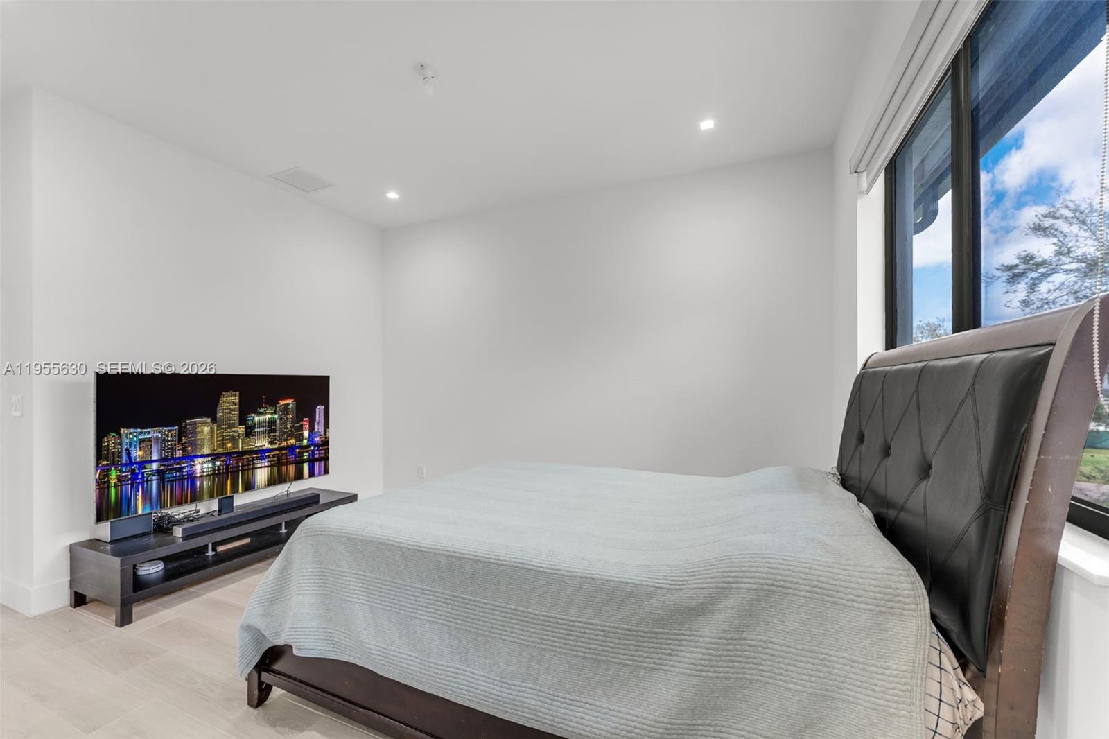 4950 Southwest 158th Ave Ranches Southwest Ranches, FL 33331 - Photo 51 of 75 a bedroom with furniture and a flat screen tv