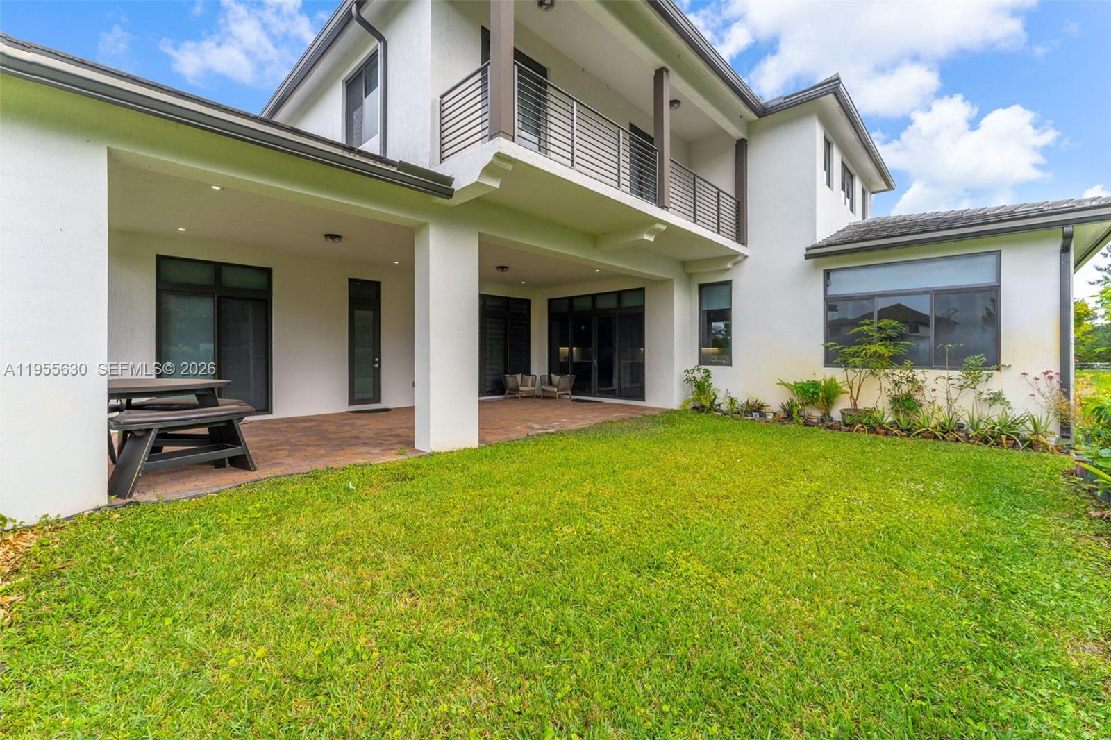4950 Southwest 158th Ave Ranches Southwest Ranches, FL 33331 - Photo 60 of 75 a view of a patio with table and chairs and potted plants