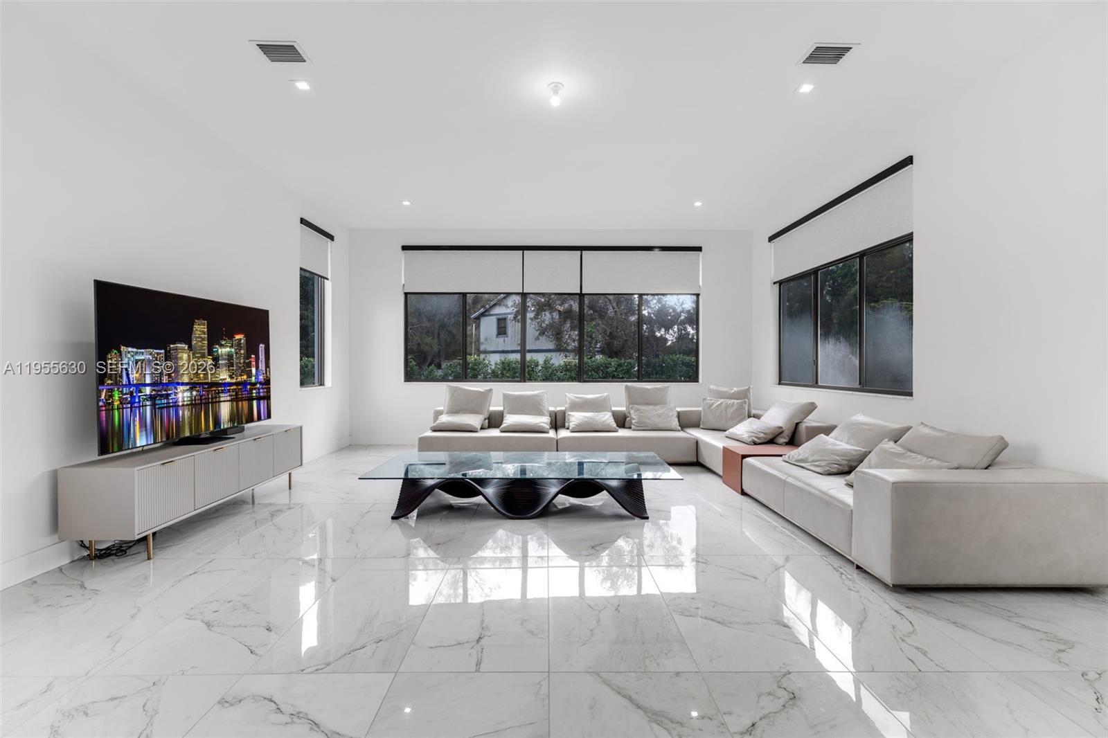4950 Southwest 158th Ave Ranches Southwest Ranches, FL 33331 - Photo 10 of 75 a living room with furniture and a flat screen tv