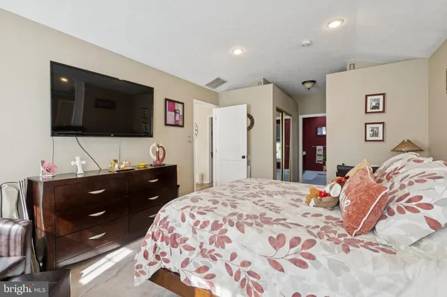 a bedroom with a bed and a flat screen tv