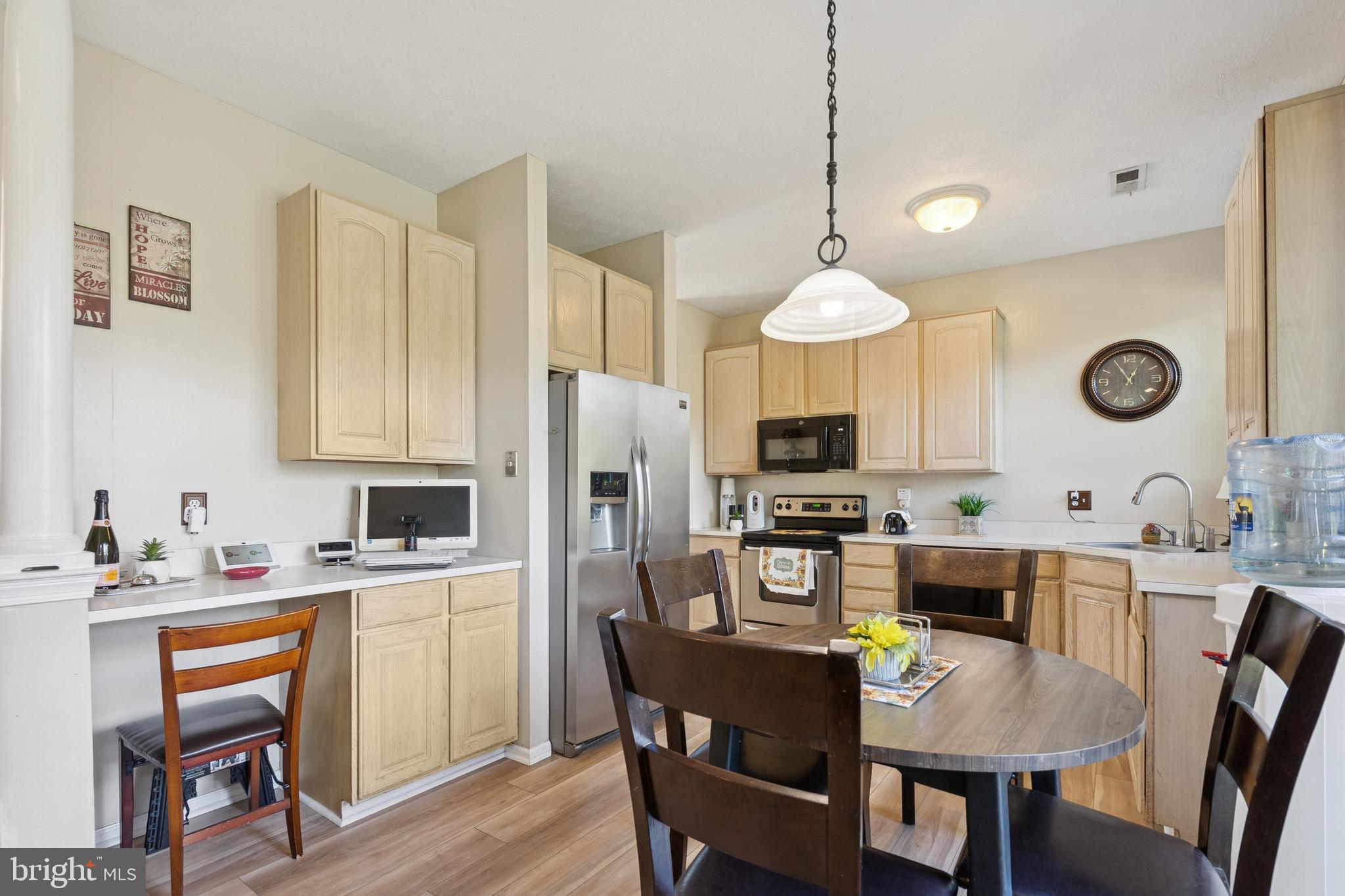 7 Meadowbrook Drive Westampton, NJ 08060 - Photo 10 of 25 a kitchen with stainless steel appliances a table chairs and a refrigerator