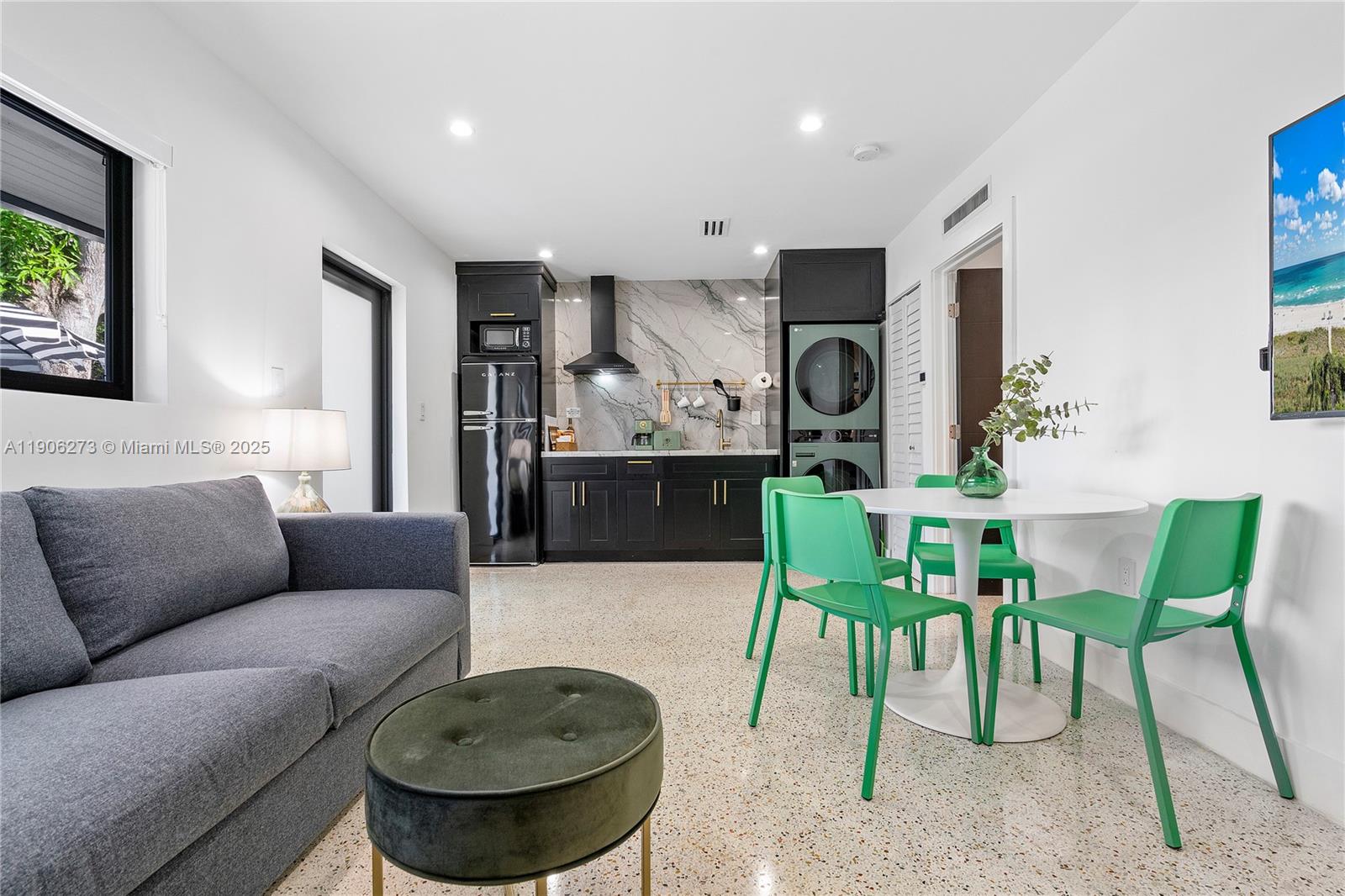 256 Northwest 57th Street Miami, FL 33127 - Photo 13 of 45 a living room with furniture and a wooden floor