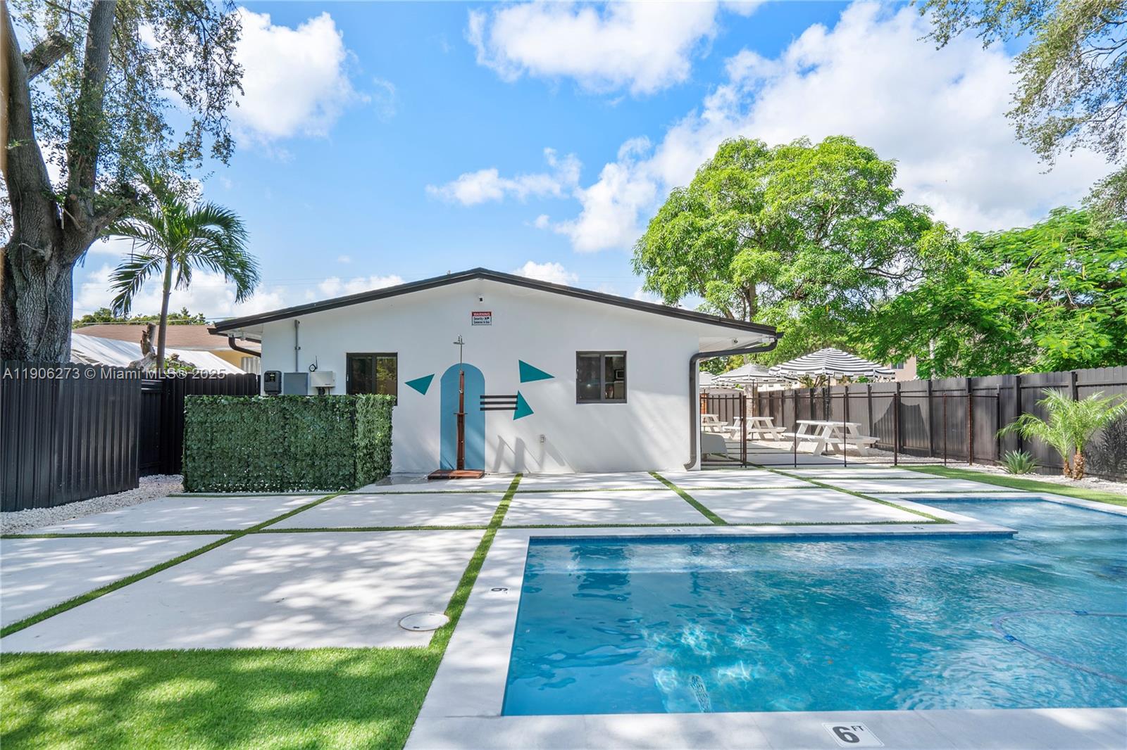 256 Northwest 57th Street Miami, FL 33127 - Photo 17 of 45 a house with view of trees in the background