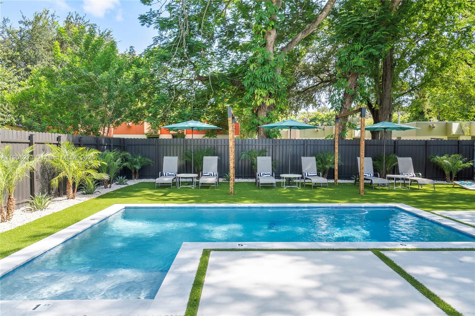 256 Northwest 57th Street Miami, FL 33127 - Photo 19 of 45 a view of swimming pool with a patio and yard