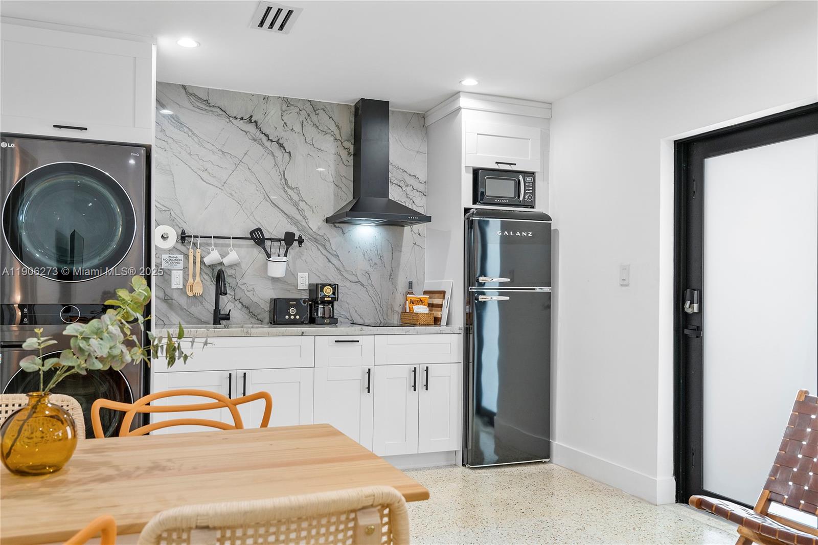 256 Northwest 57th Street Miami, FL 33127 - Photo 22 of 45 a kitchen with stainless steel appliances granite countertop a refrigerator and a sink