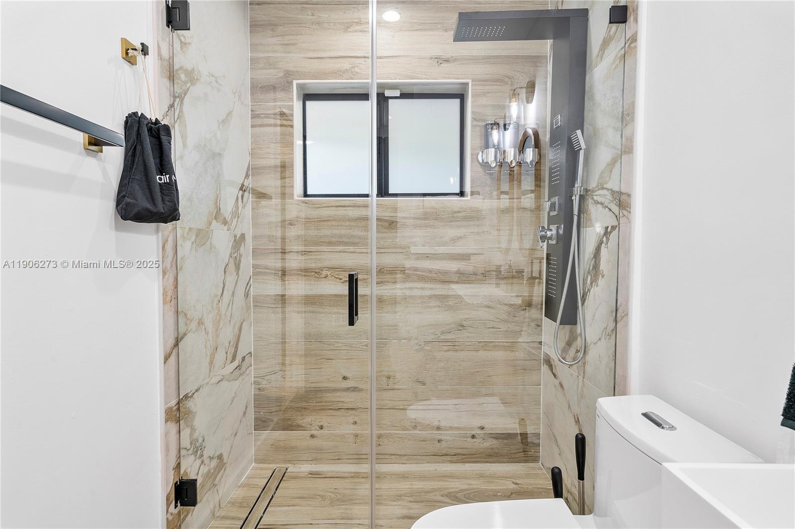 256 Northwest 57th Street Miami, FL 33127 - Photo 28 of 45 a bathroom with a shower a toilet and a sink