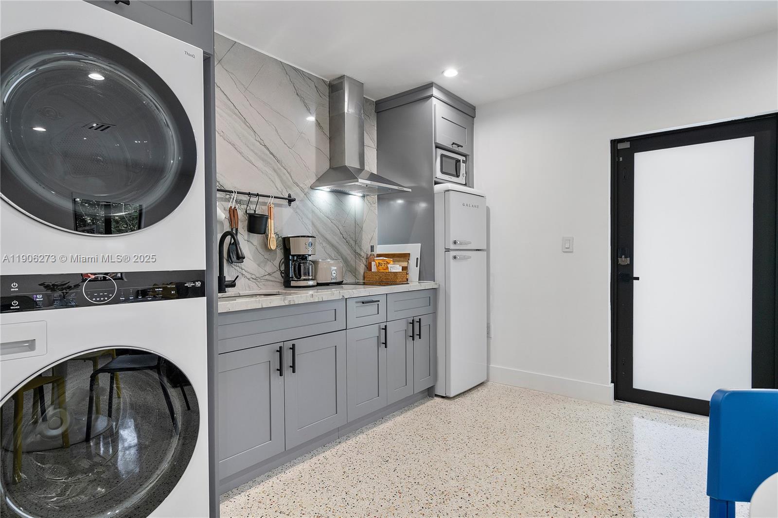 256 Northwest 57th Street Miami, FL 33127 - Photo 31 of 45 a kitchen with a sink and a washer dryer