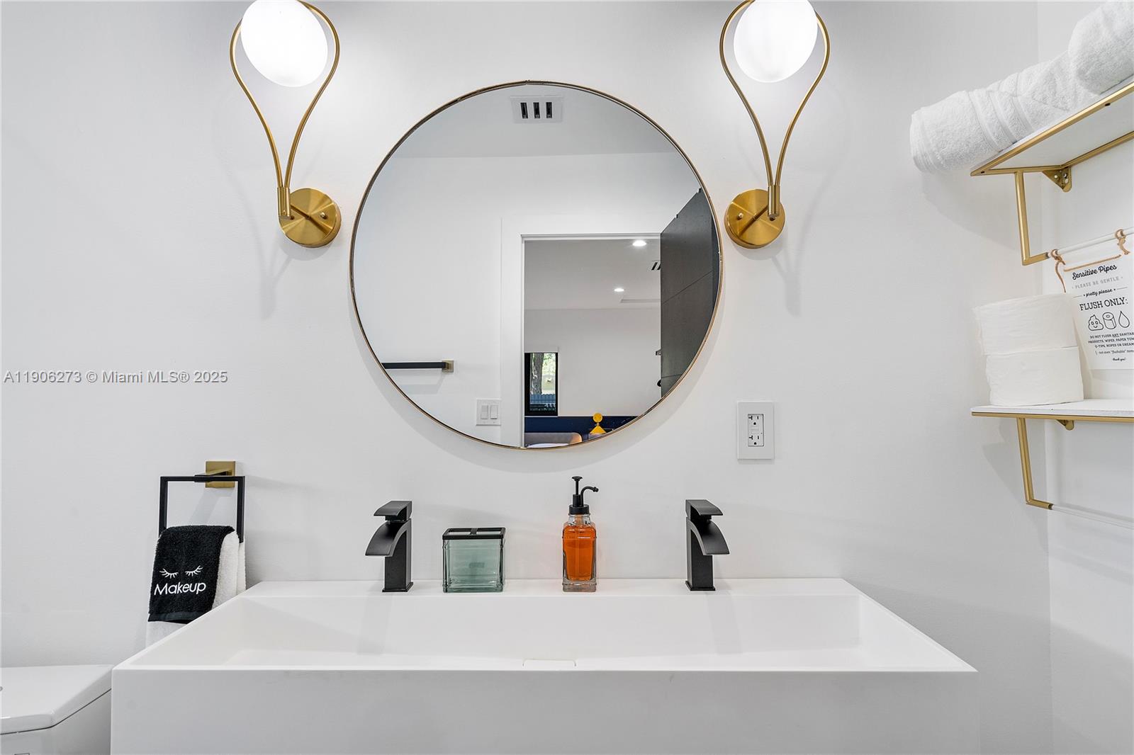 256 Northwest 57th Street Miami, FL 33127 - Photo 35 of 45 a bathroom with a sink and a mirror