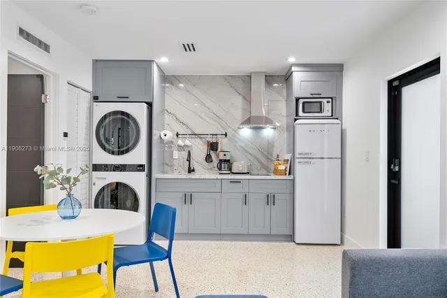 a bedroom with a bed and a couch with window