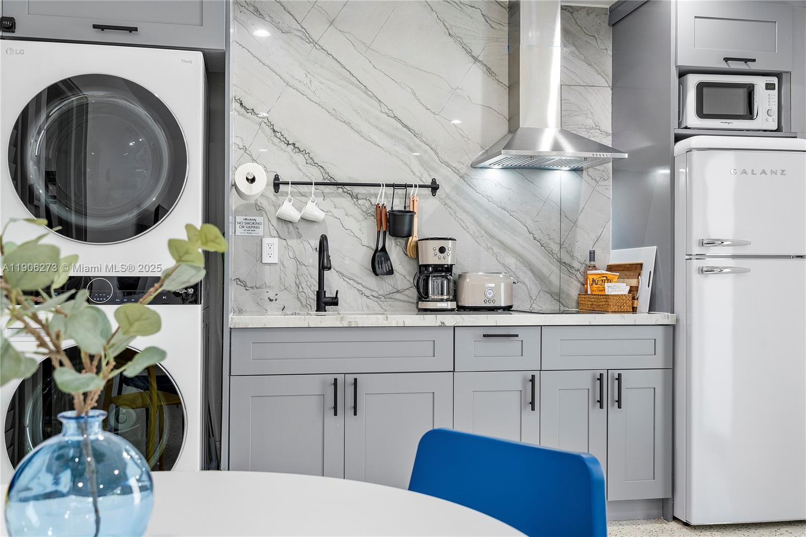 256 Northwest 57th Street Miami, FL 33127 - Photo 39 of 45 a bathroom with a sink a mirror and toilet