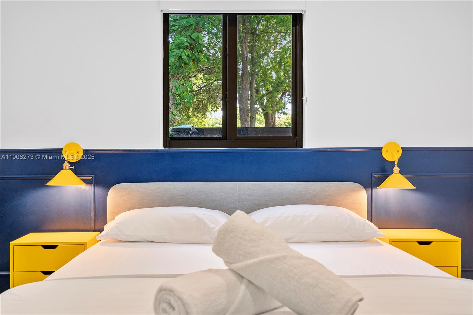 256 Northwest 57th Street Miami, FL 33127 - Photo 40 of 45 a bedroom with a bed and a couch with window