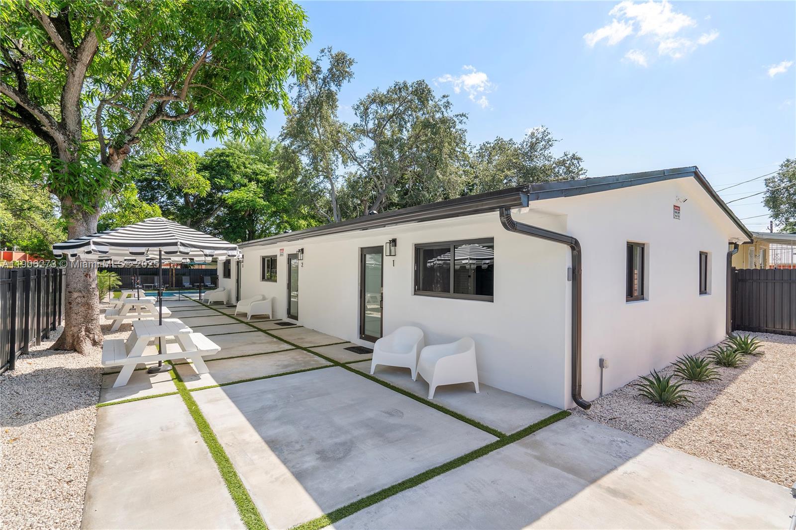 256 Northwest 57th Street Miami, FL 33127 - Photo 44 of 45 a front view of house with yard patio and seating space